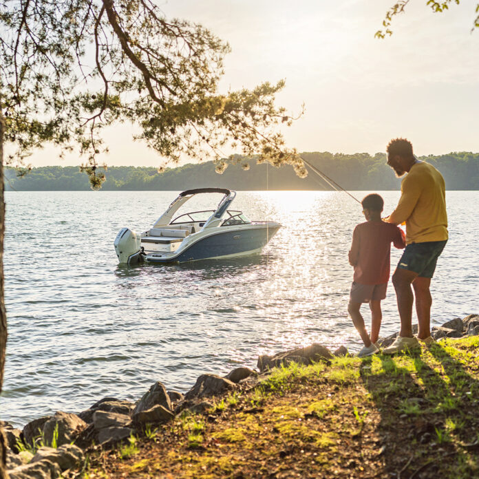 Family fishing next to an SDX 230 Outboard