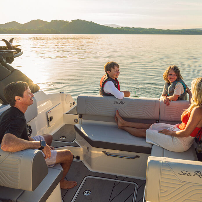 Family aboard an SDX 230 Surf at sunset