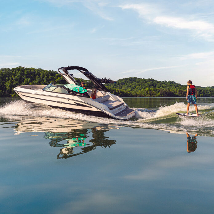 Kid wakesurfing behind an SDX 230 Surf