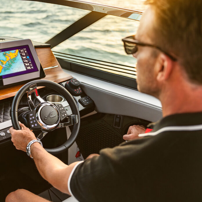 Man at the helm of an SLX 360 Outboard