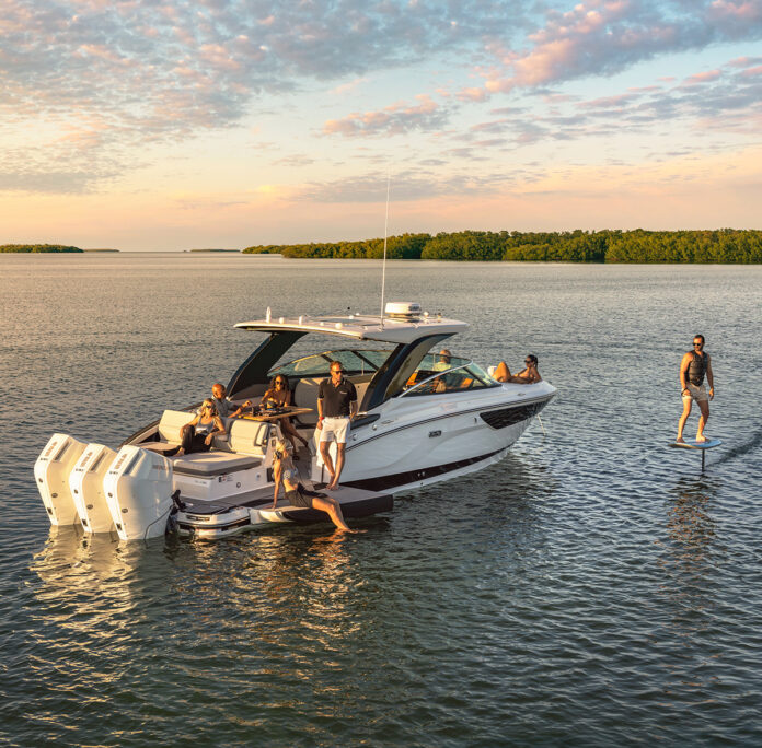 Man foilboarding next to an SLX 360 Outboard